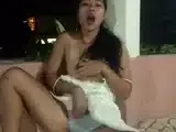 Tiny-titted Asian babe plays with herself outdoors