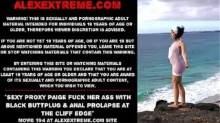 Sexy Proxy Paige fuck her ass with black buttplug & anal prolapse at the cliff edge