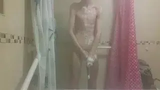 Hot very skinny guy with flat butt strokes his wet cock and pisses